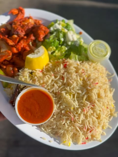 An AMAYE plated meal with rice, salad and sauce.